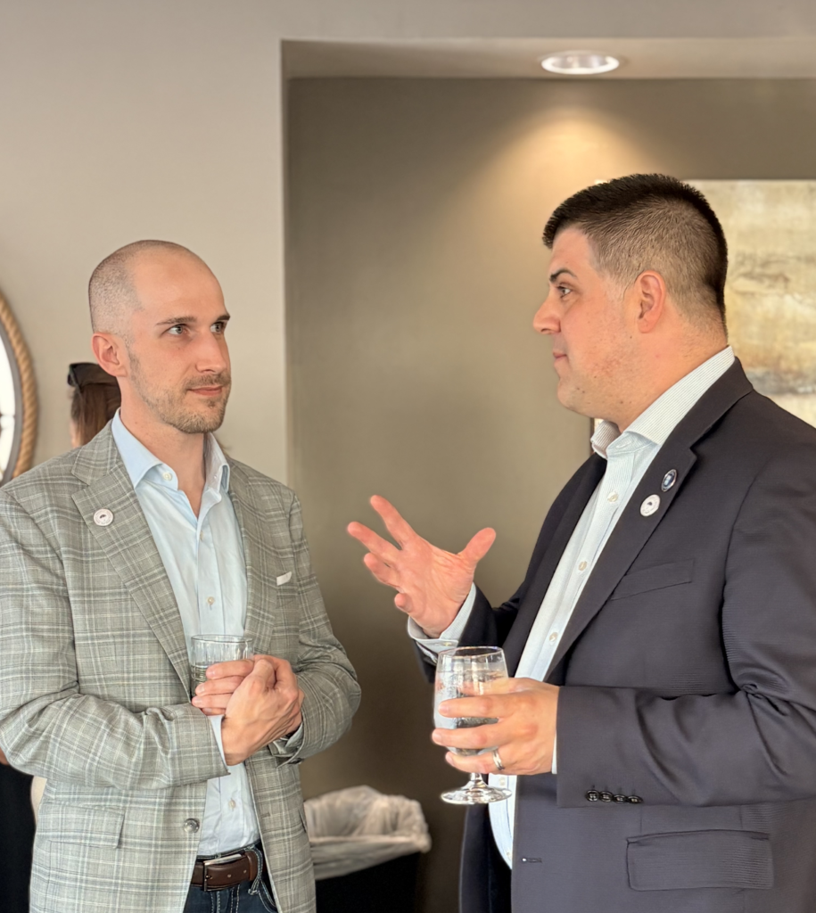 Two coalition members converse during a reception at an ANOHC event.